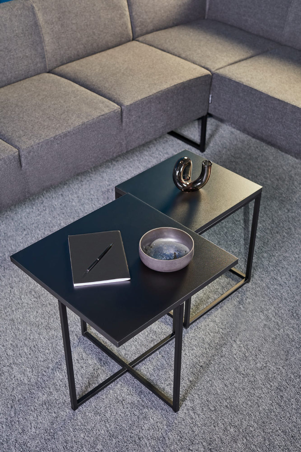 Verso Upholstered Modular Sofa in Grey Finish with Black Coffee Table in Living Room Setting