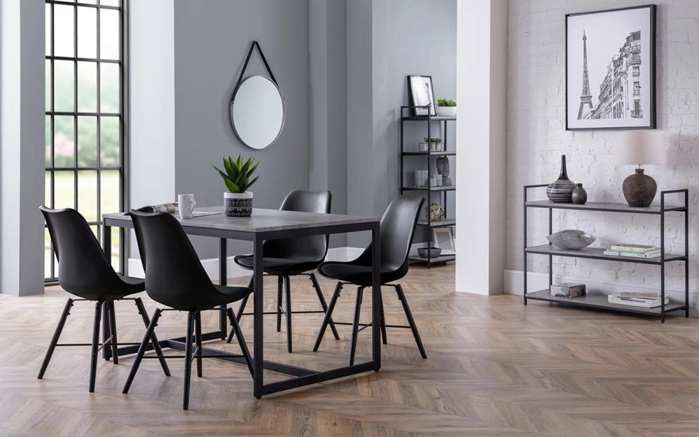 Adele Concrete Dining Table with Black Chairs and Round Wall Mirror in Breakout Setting