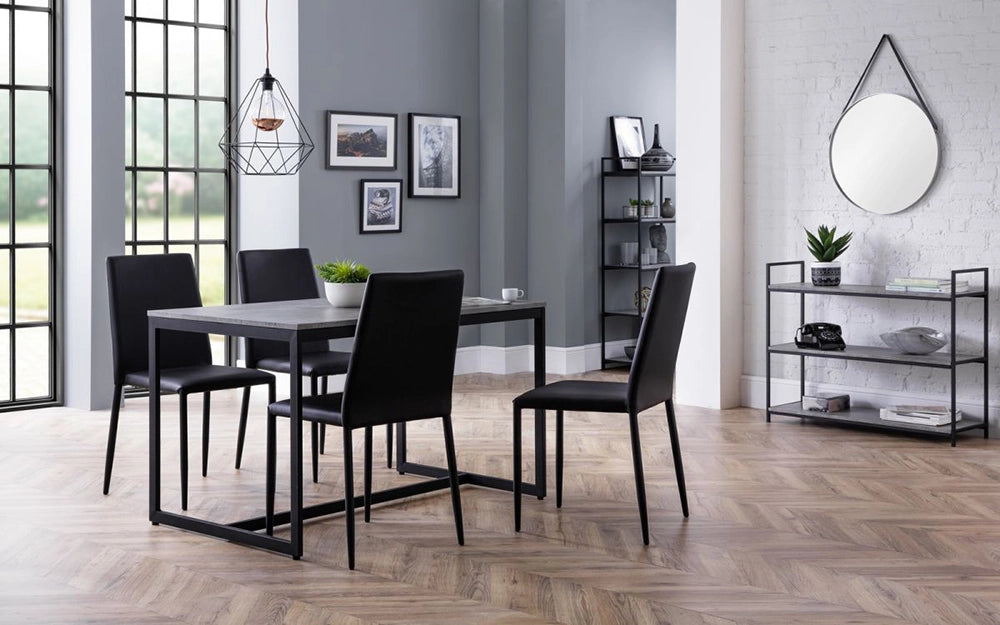Adele Concrete Dining Table with Black Chairs and Wall Frame in Breakout Setting
