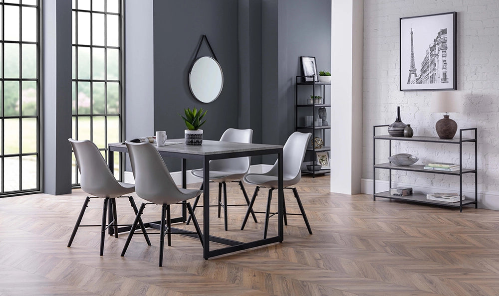 Adele Concrete Dining Table with Grey Chairs and Round Wall Mirror in Breakout Setting