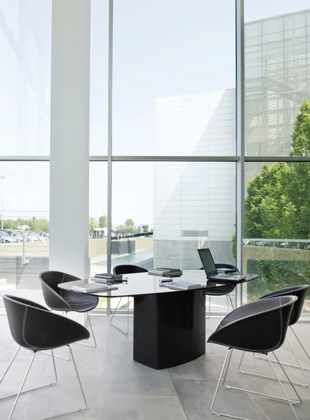 Aero Dining Table in Black Finish with Tub Chair in Breakout Setting