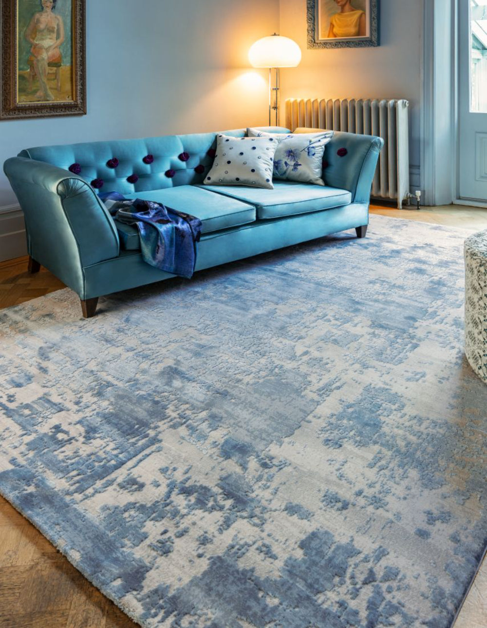 Alexis Floor Rug in Blue Finish with Sofa and Floor Lamp in Living Room Setting