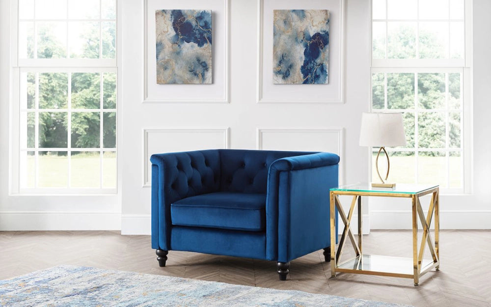 Andre Tufted Armchair in Blue Velvet Finish with Glass Top Table and White Lamp Shade in Living Room Setting