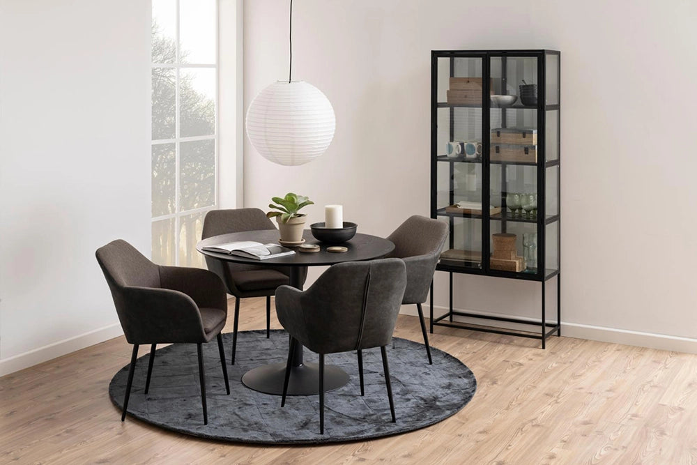 Antonio Round Dining Table in Black Finish with Upholstered Lounge Chair and Cabinet in Breakout Setting