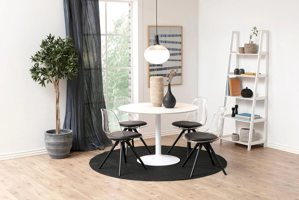 Antonio Round Dining Table in White Finish with Padded Chair and Indoor Plant in Breakout Setting
