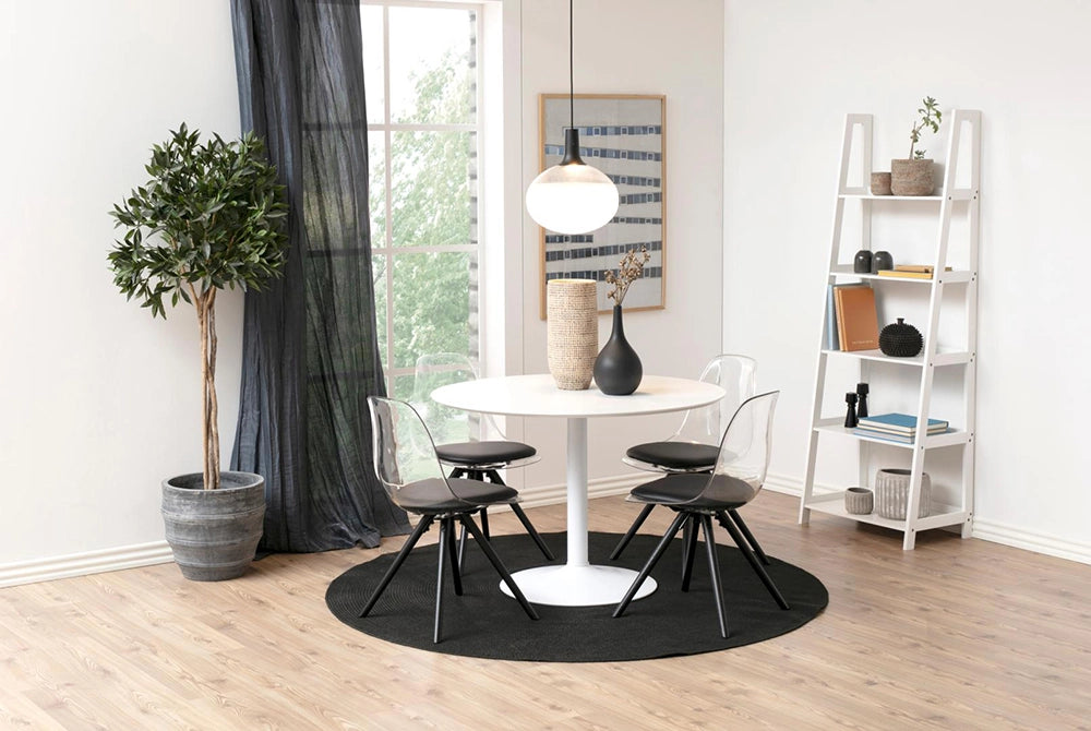 Antonio Round Dining Table in White Finish with Transparent Chair and Wisker Vase in Breakout Setting