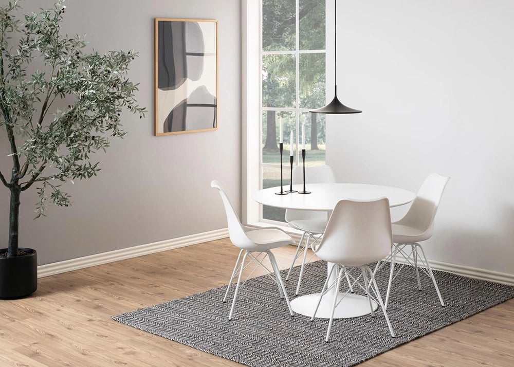 Antonio Round Dining Table in White Finish with White Chair and Indoor Plant in Breakout Setting