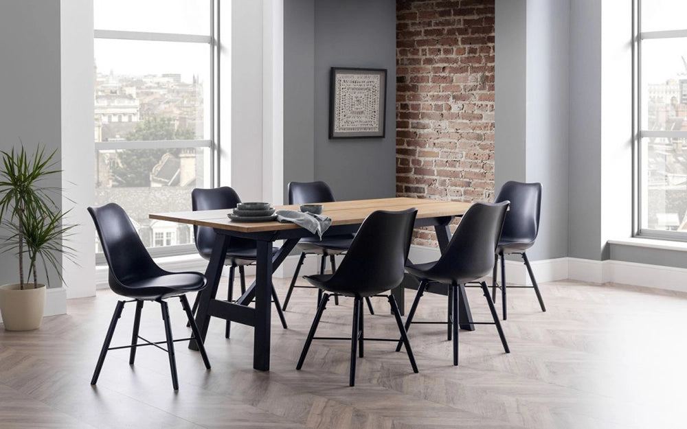 Ava Dining Table in Black Oak Finish with Six Plastic Chairs and Wall Frame in Breakout Setting