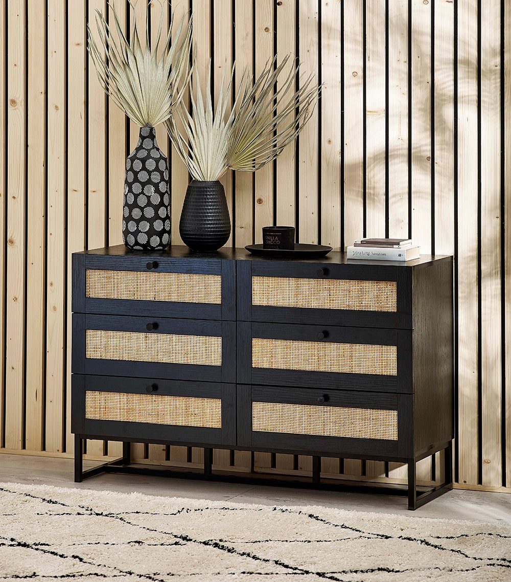 Bari 6 Drawer Chest in Black Finish with Black Vase and Books in Living Room Setting