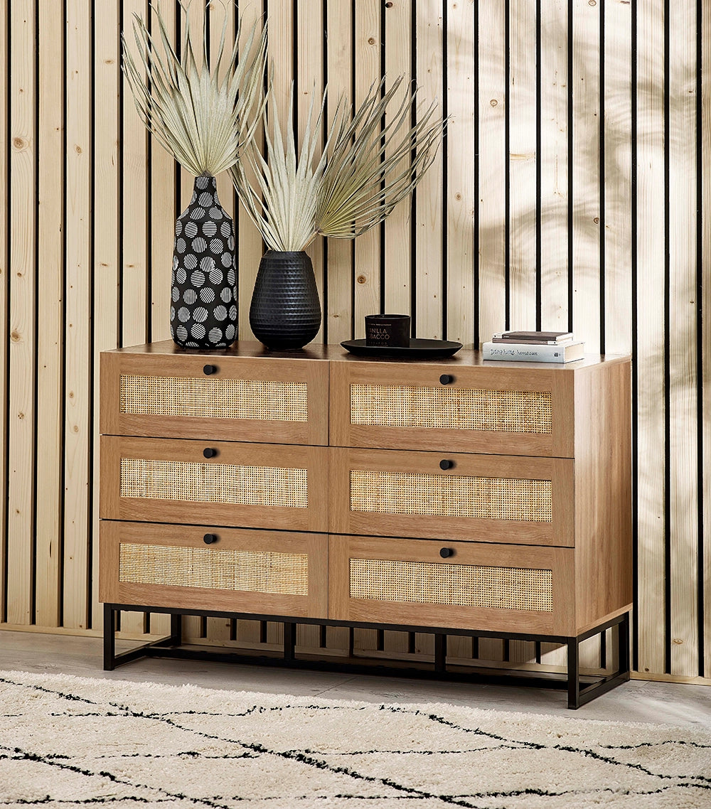 Bari 6 Drawer Chest in Oak Finish with Black Vase and Books in Living Room Setting