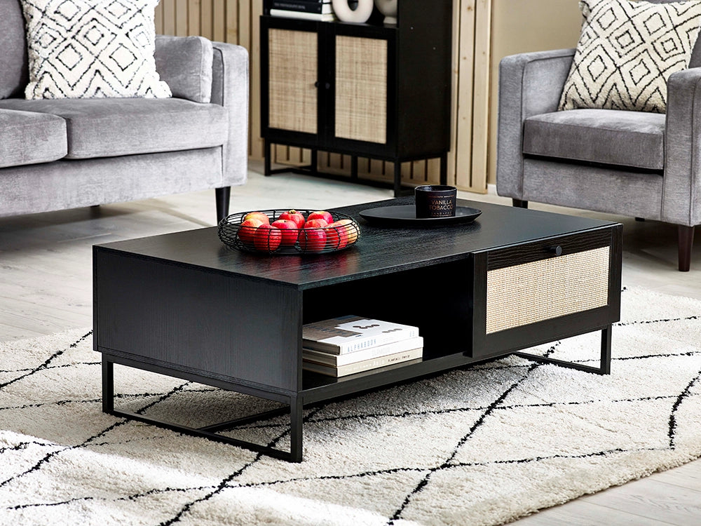 Bari Coffee Table in Black Finish with Upholstered Grey Armchair and Books in Living Room Setting