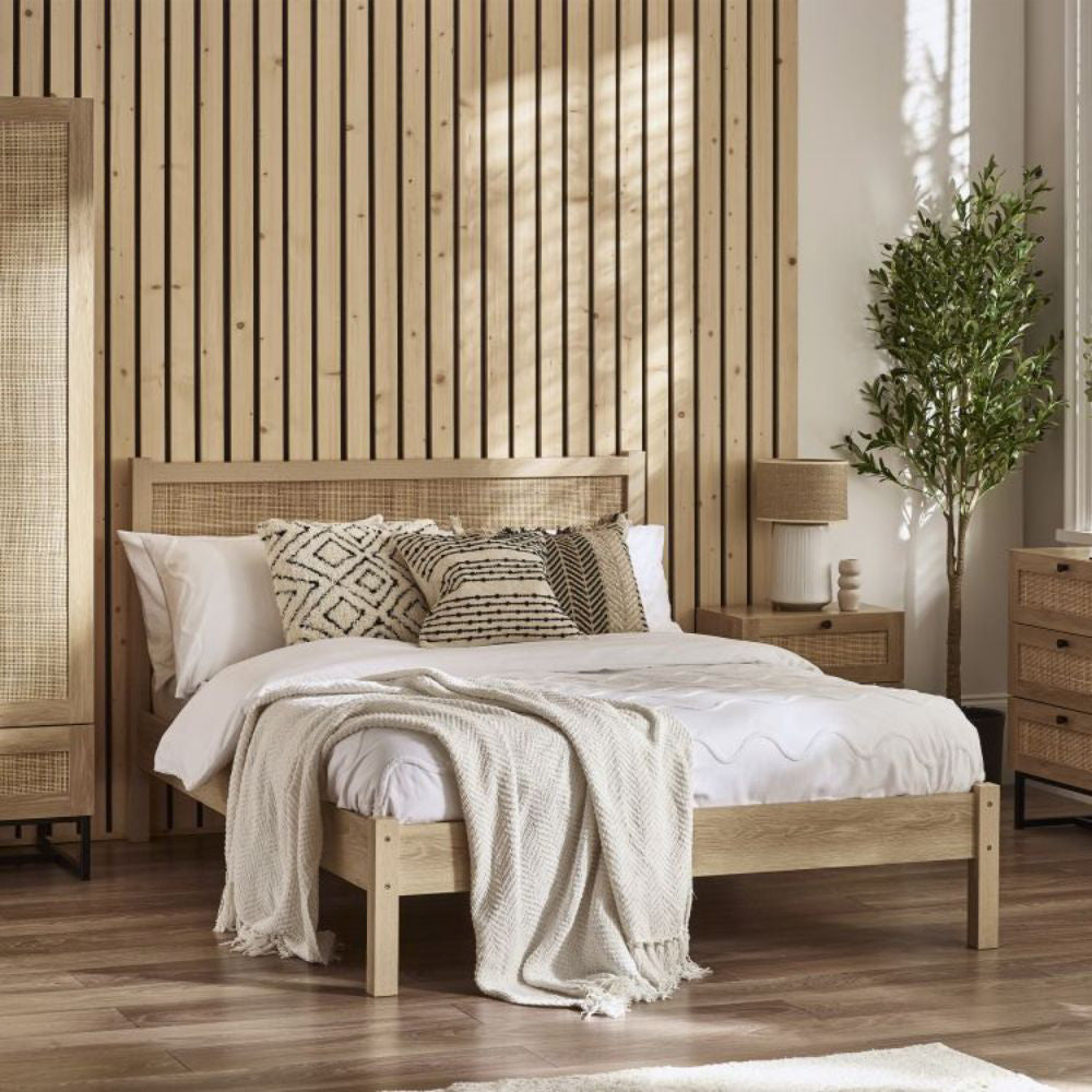 Bari Rattan Bed Frame in Oak Finish with Wardrobe and Indoor Plant in Bedroom Setting