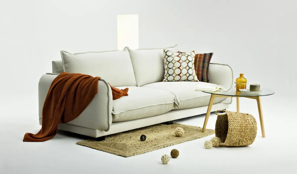 Barrett 3 Seater Sofa in White Finish with Round Coffee Table and Floor Rug in Studio Setting