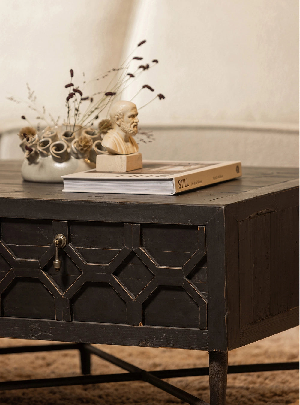 Bella Coffee and TV Table in Black Finish with Upholstered Carpet and Vase in Living Room Setting