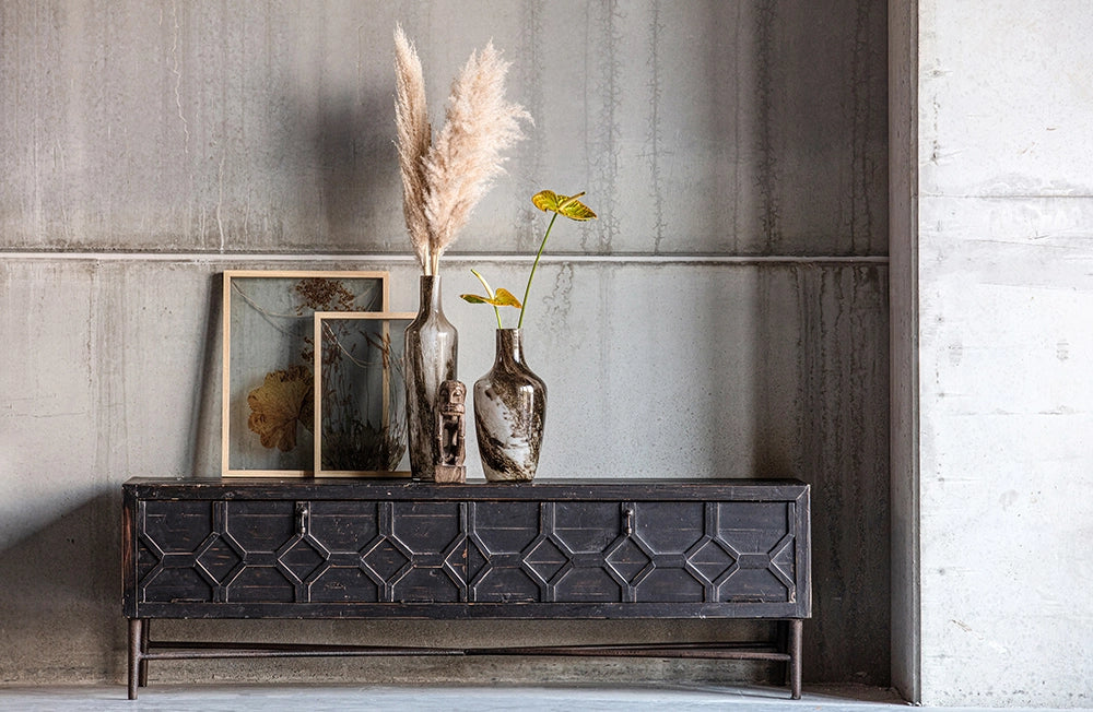 Bella TV Unit in Black Finish with Glass Vase and Indoor Plant in Living Room Setting