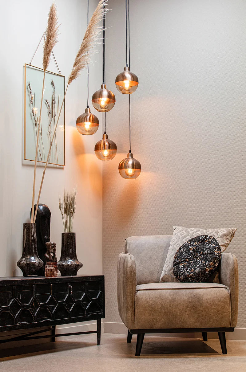 Bella TV Unit with Upholstered Armchair and Hanging Lights in Living Room Setting