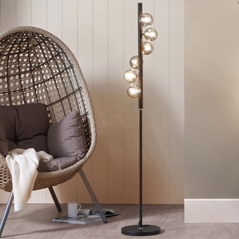 Blay Smoke Glass Ball and Black Metal Floor Lamp with Lounge Chair in Breakout Setting