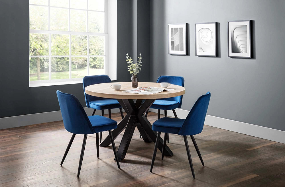 Burnwick Round Dining Table in Wooden Finish with Blue Fabric Chair and Wall Frame in Breakout Setting