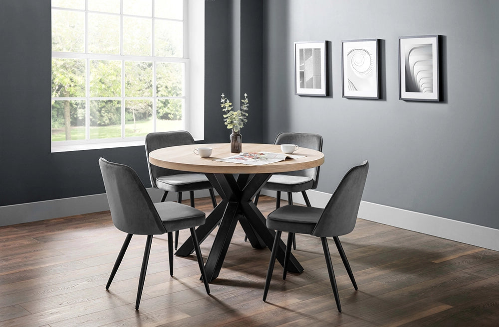 Burnwick Round Dining Table in Wooden Finish with Grey Tub Chair and Wall Frame in Breakout Setting 2