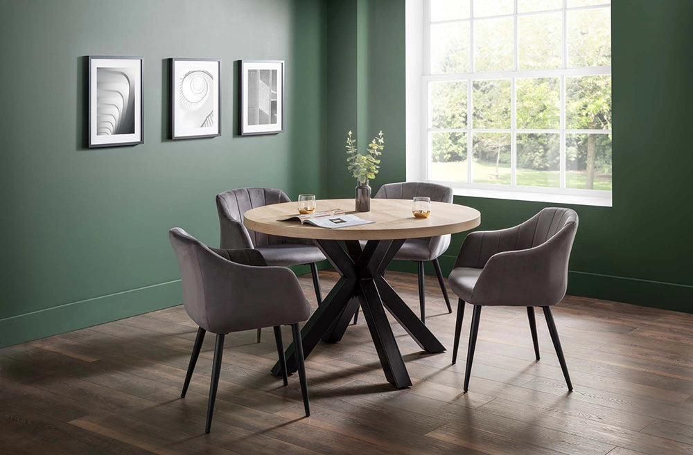 Burnwick Round Dining Table in Wooden Finish with Grey Tub Chair and Wall Frame in Breakout Setting