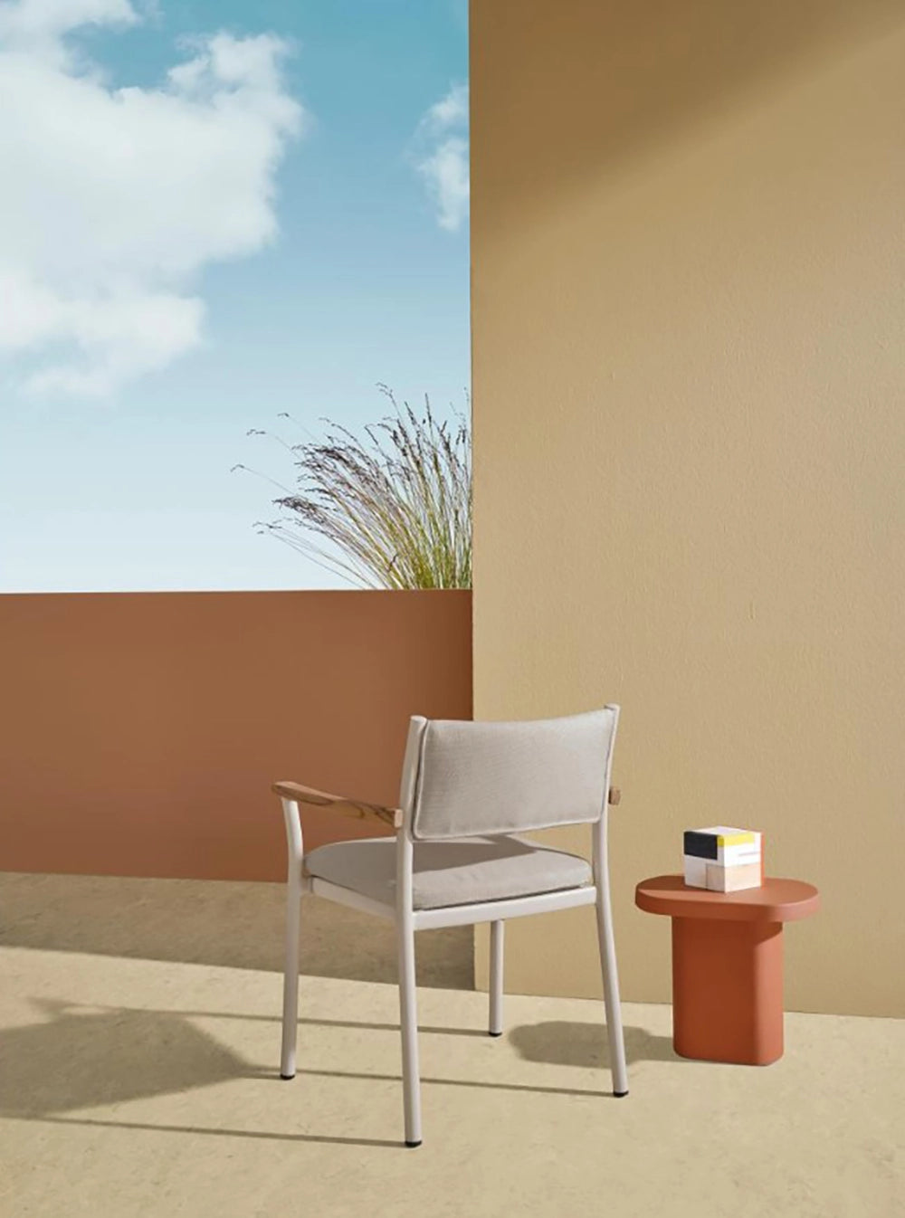 Caementum Monobloc Coffee Table in Orange Finish with Lounge Armchair in Studio Setting 2