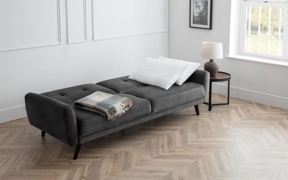 Capri Sofa Bed Dark Grey Velvet with Side Table and Lampshade in Living Room Setting
