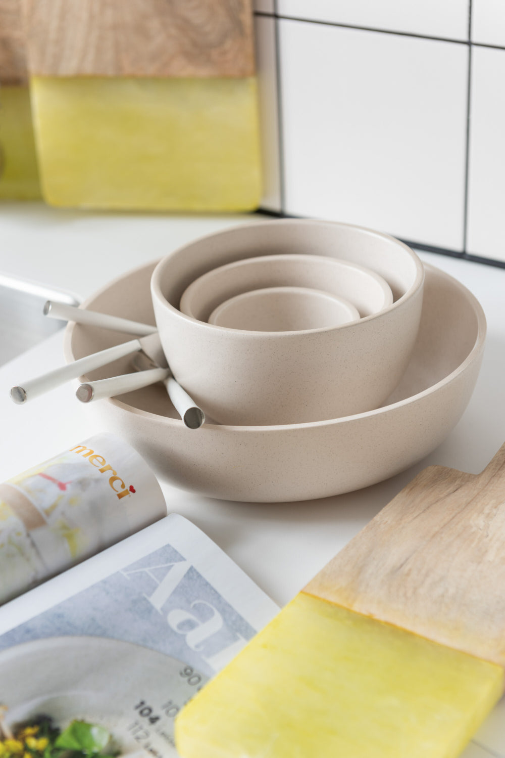 Cream Ceramic Pasta Bowl in Ivory Finish with Utensils and Soup Bowl in Kitchen Setting