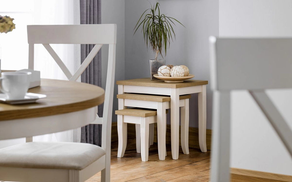 Davina Oak Top Nesting Table in Ivory Finish with Wooden Chair and Vase in Dining Setting