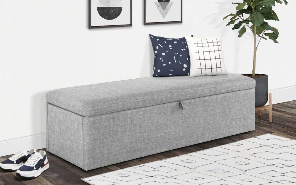 Delmar Upholstered Blanket Box in Light Grey Finish with Cushion and Wall Art in Living Room Setting