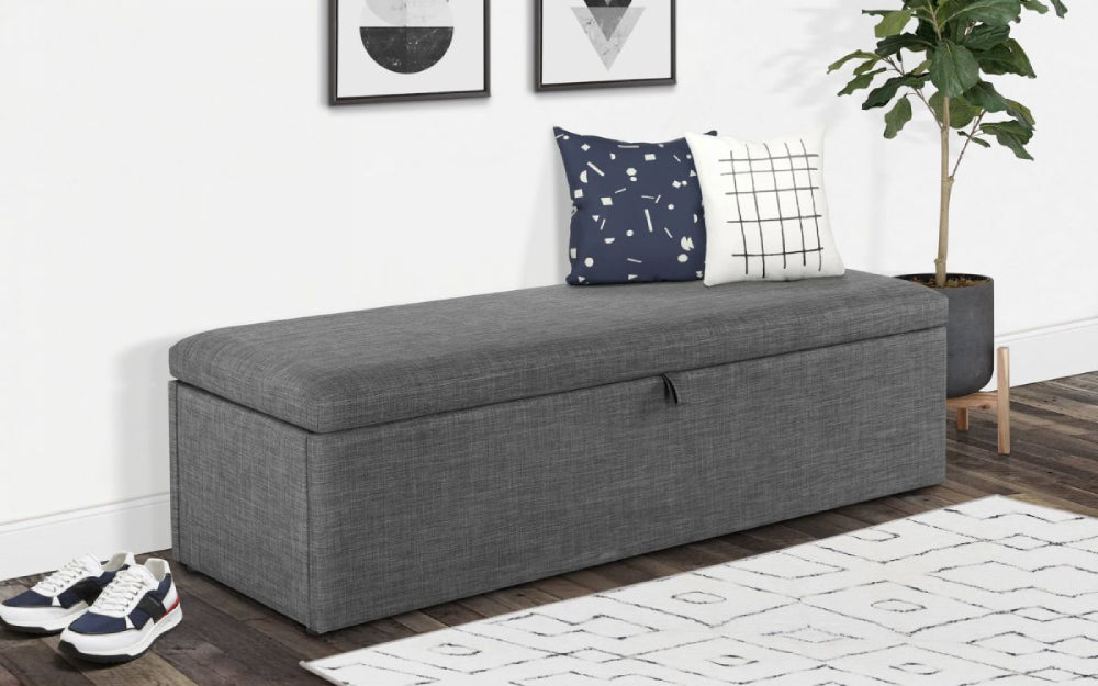 Delmar Upholstered Blanket Box in Slate Grey Finish with Cushion and Wall Art in Living Room Setting