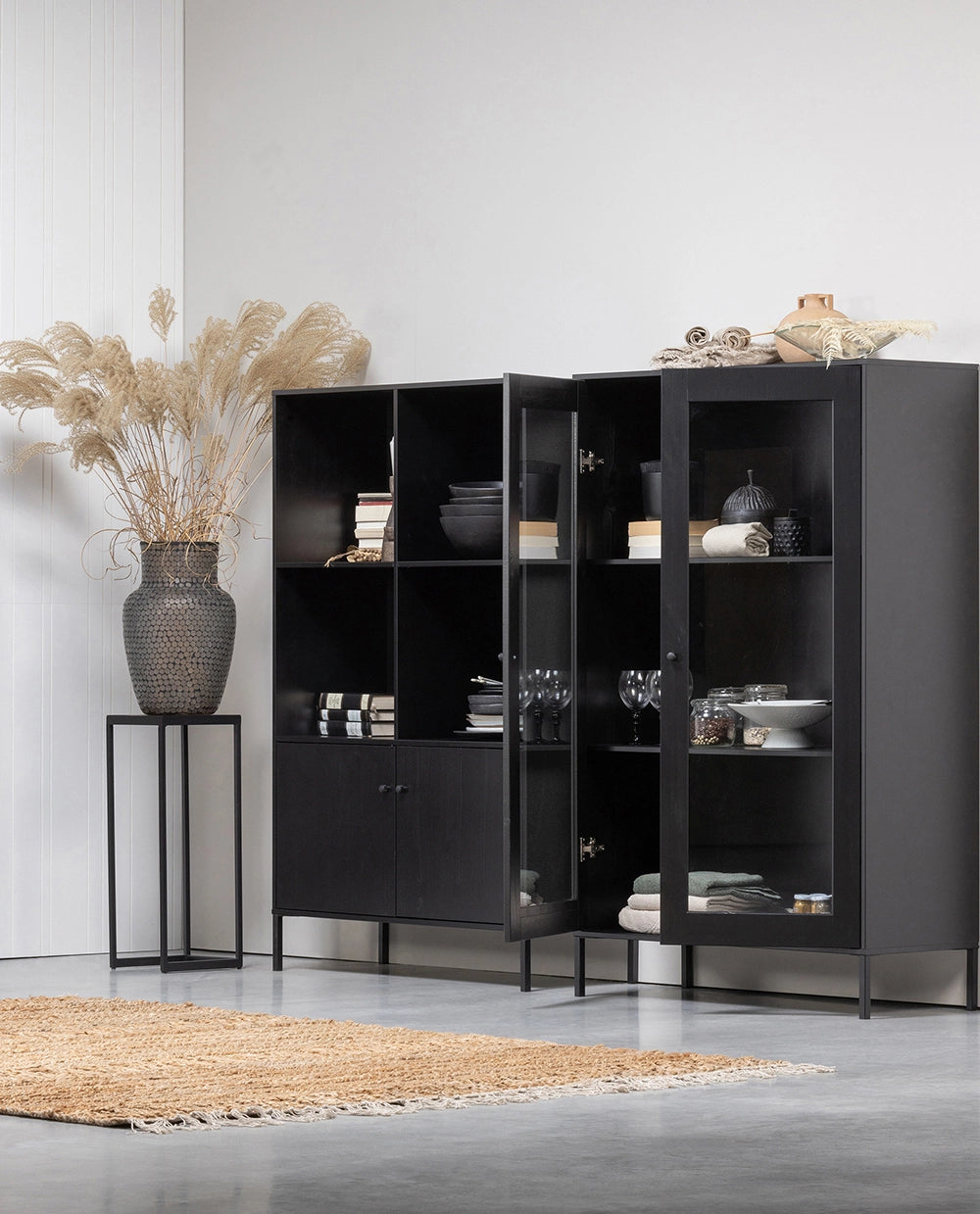 Edame Display Cabinet in - Black Finish with Utensils and Dried Plant in Living Room Setting