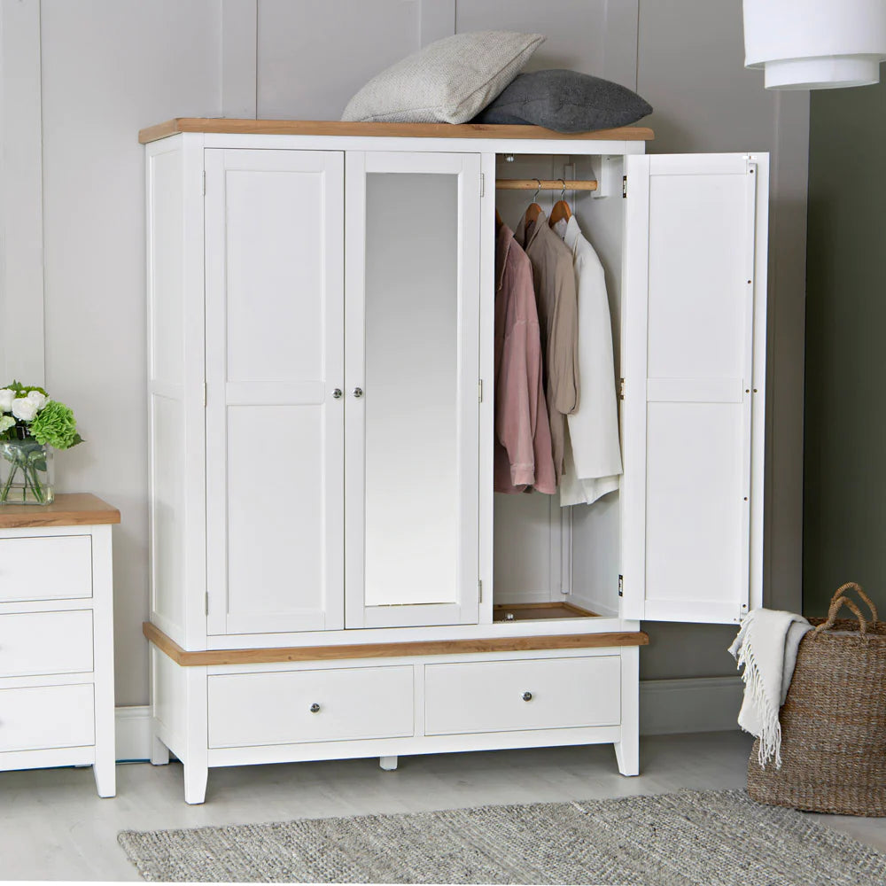 Elias 3 Door Wardrobe in White Finish with Laundry Basket and Flower Vase in Bedroom Setting