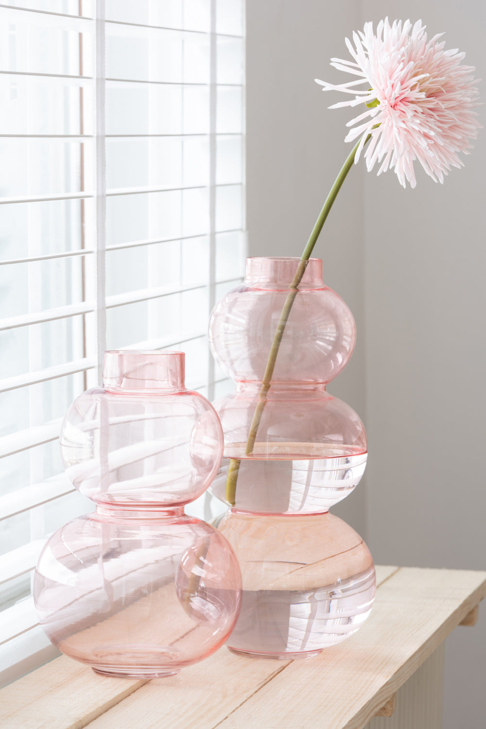 Glass Globe Shaped Large Vase in Pink Finish with Table in Living Room Setting