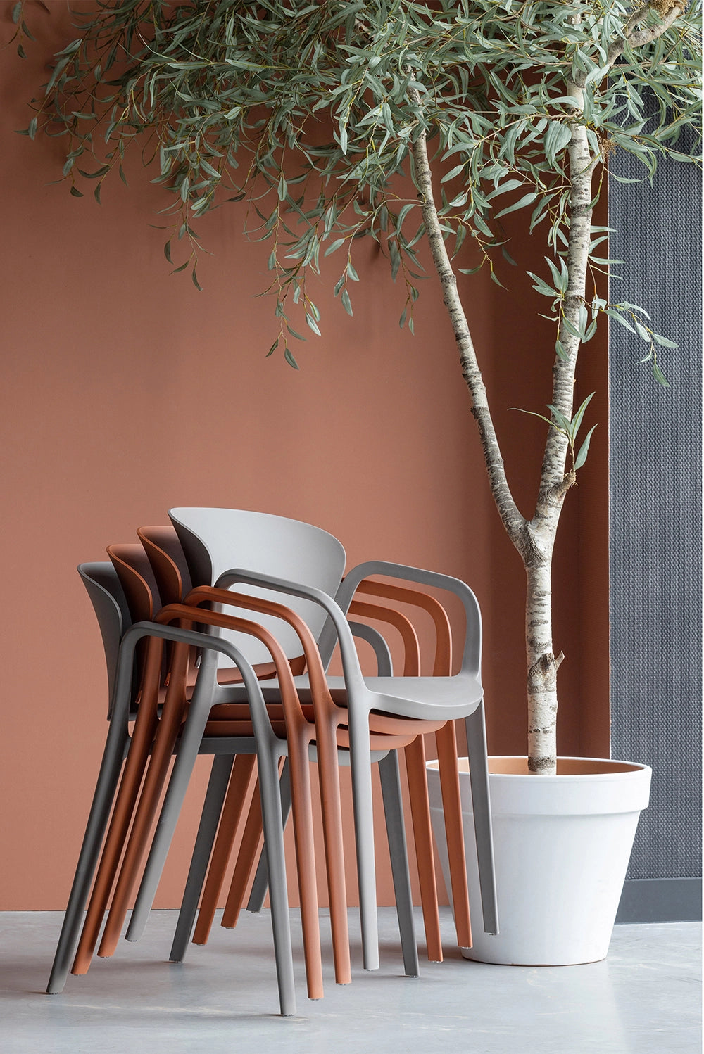 Greta Polypropylene Chair - Taupe Stacked Chairs with Indoor Plant in White Pot