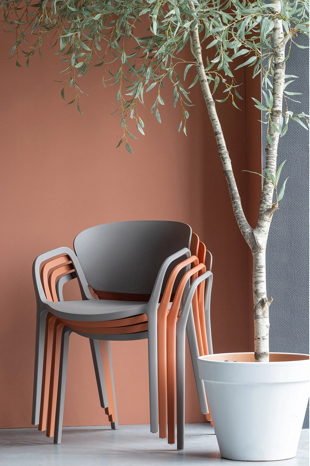 Greta Polypropylene Chair - Terra 7 Stacked Chairs with Indoor Plant in White Pot