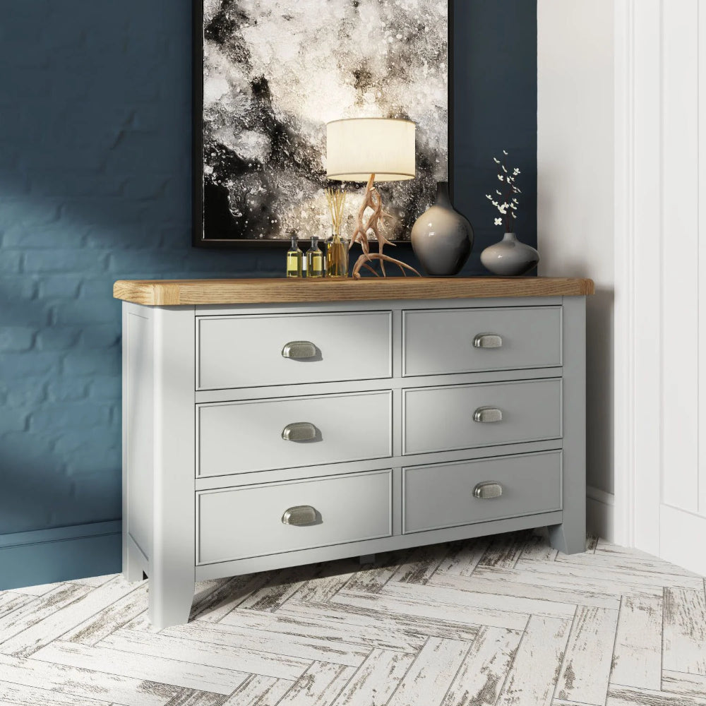 Hadley 6 Drawer Chest in Grey Finish with Lampshade and Flower Vase in Bedroom Setting