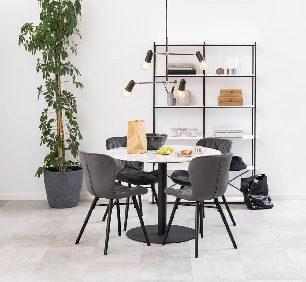 Hampton Round Dining Table in Marble Black Finish with Grey Chair and Indoor Plant in Breakout Setting