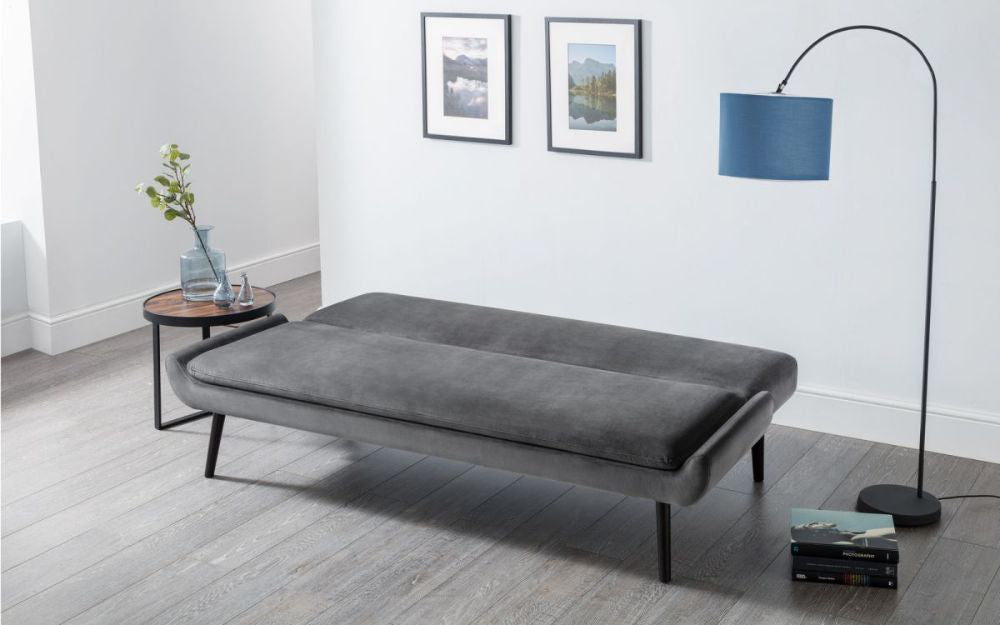 Harlan Curled Base Sofa Bed Grey Velvet with Coffee Table and Floor Lamp in Living Room Setting 2