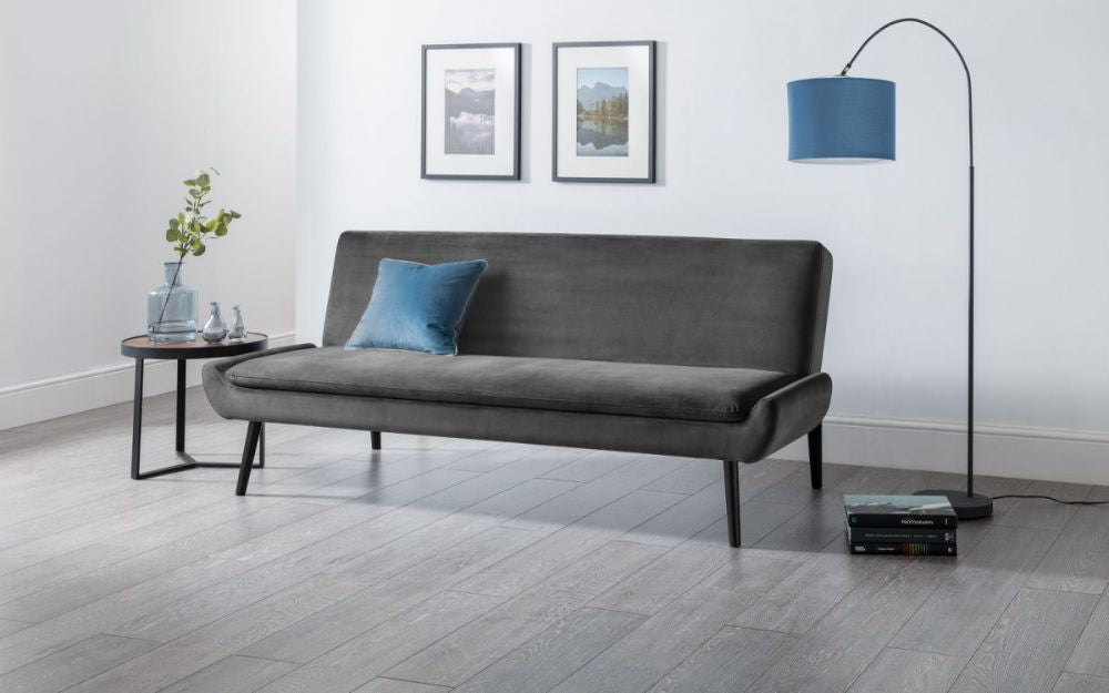 Harlan Curled Base Sofa Bed Grey Velvet with Coffee Table and Floor Lamp in Living Room Setting