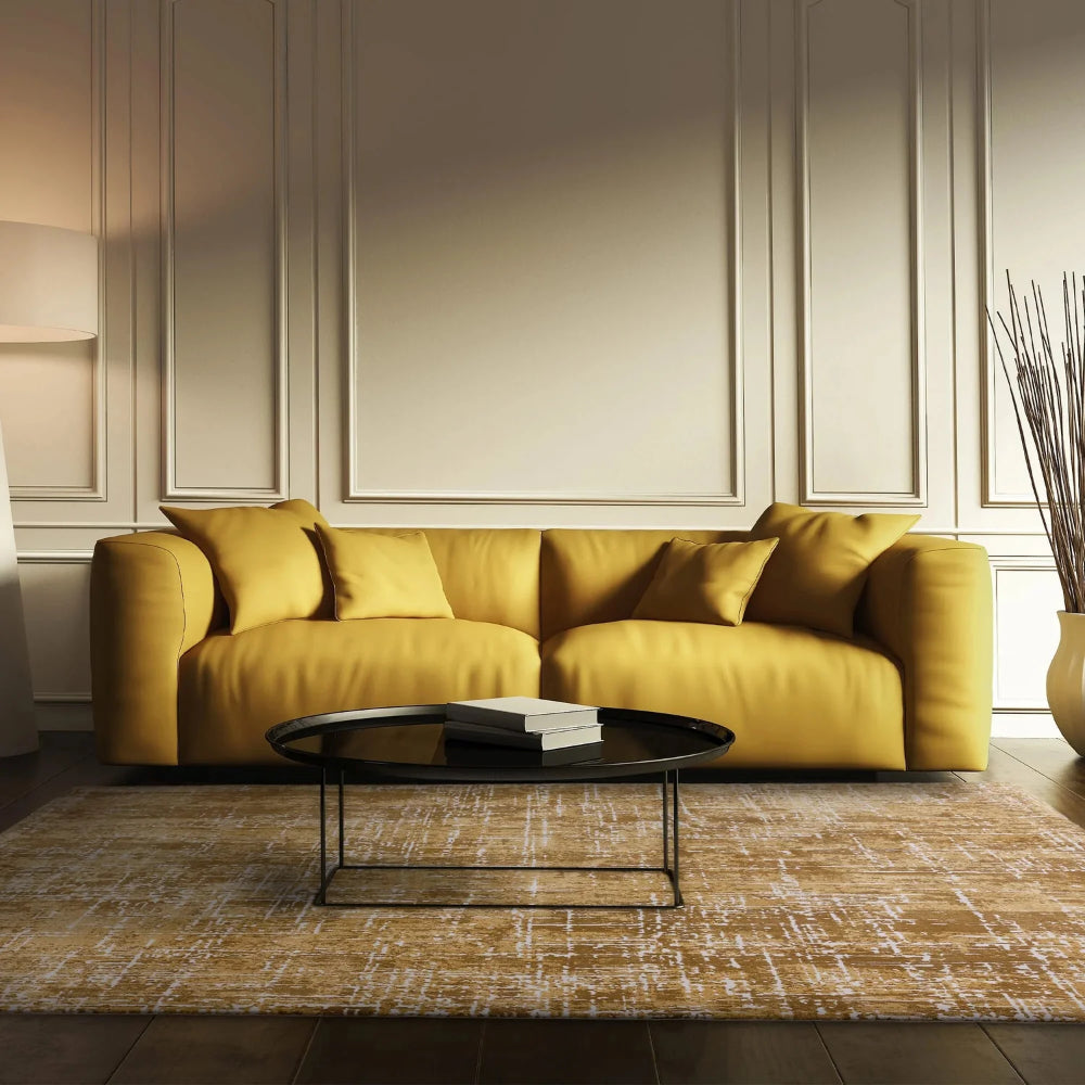 Kazzie Abstract Rug in Gold Finish with Round Coffee Table and Sofa in Living Room Setting