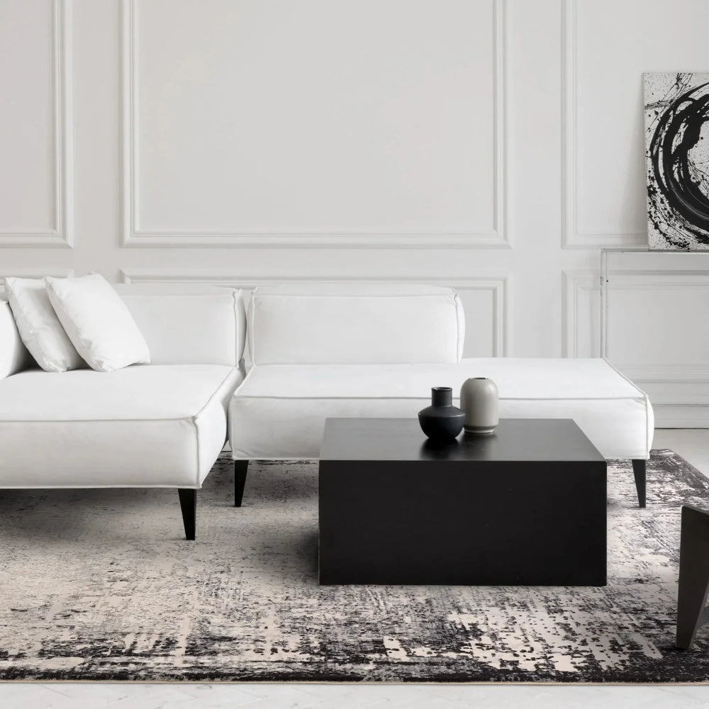 Kazzie Border Rug in Grey Finish with Modular Sofa and Coffee Table in Living Room Setting