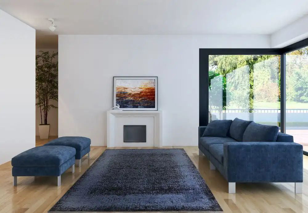 Koa Indigo and Black Rug with Modular Sofa and Pouffe in Living Room Setting