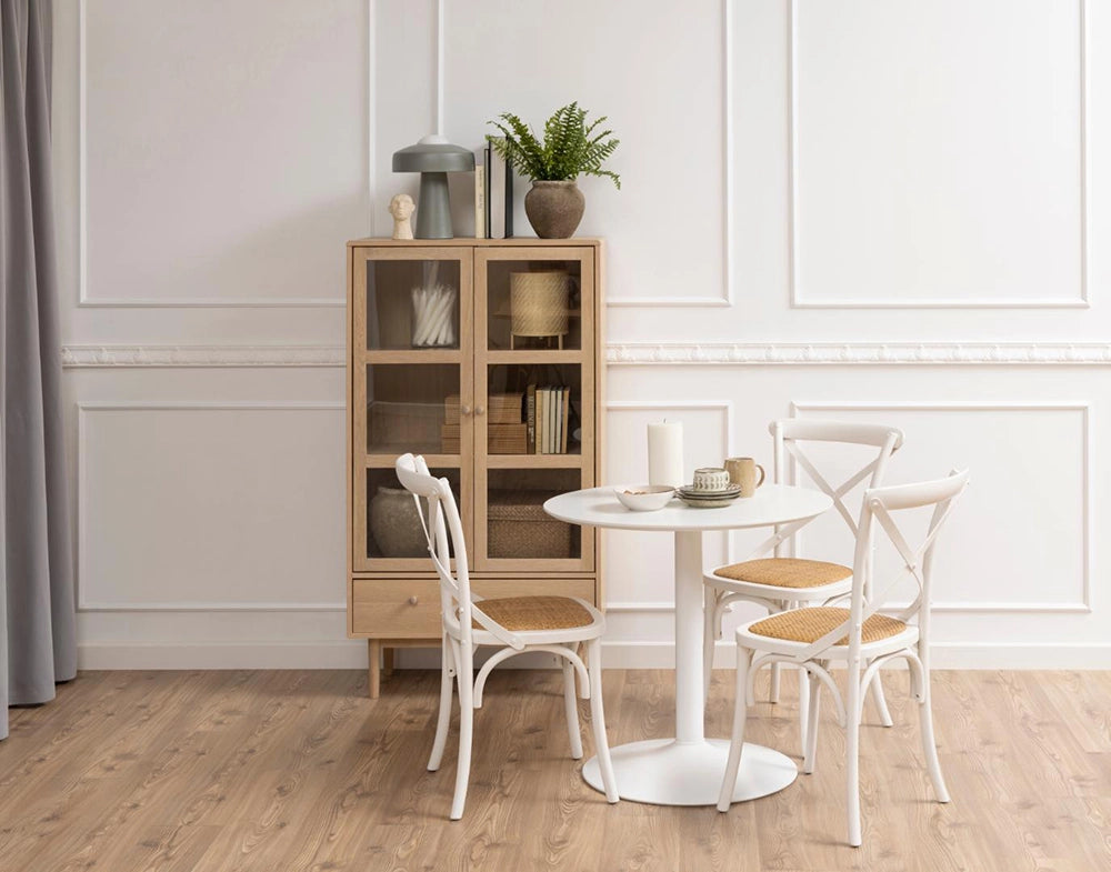 Krutcher Display Cabinet in White Oak Finish with White Round Table and Wooden Chair in Living Room Setting