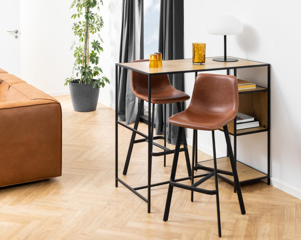 Leo Barstool with Footrest in Brandy Finish with Indoor Plant and Hightop Table in Living Room Setting 2