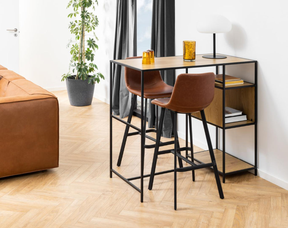 Leo Barstool with Footrest in Brandy Finish with Indoor Plant and Hightop Table in Living Room Setting