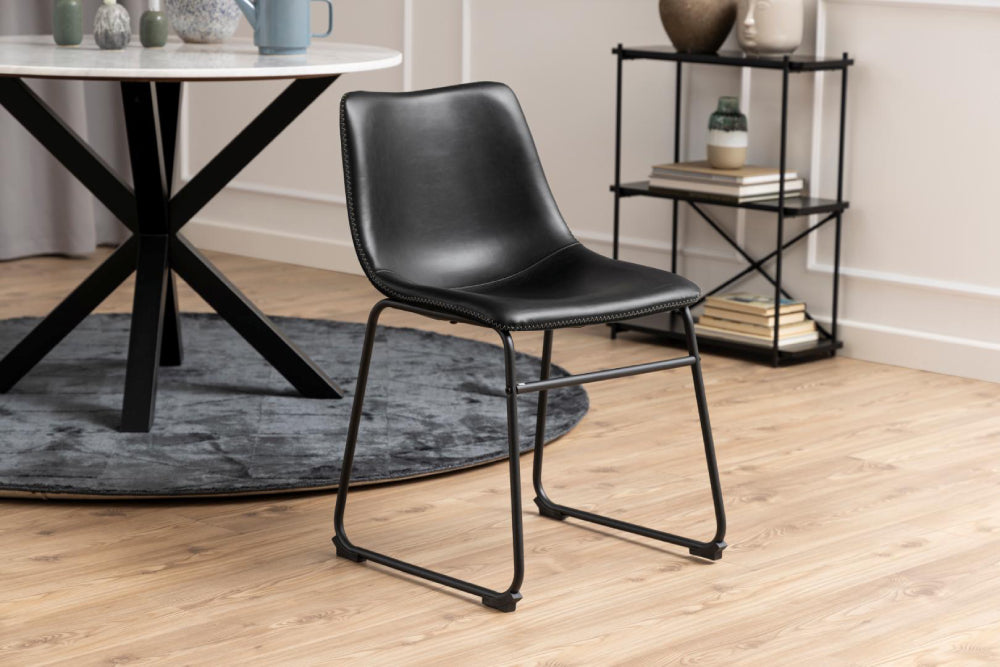 Leo Dining Chair Black PU with Round Table and Shelving Unit in Living Room Setting