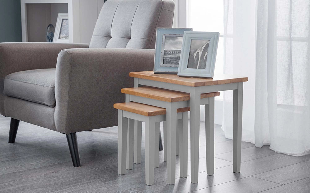 Lyon Nest Of Table in Grey Oak Finish with Upholstered Grey Armchair and Picture Frame in Living Room Setting