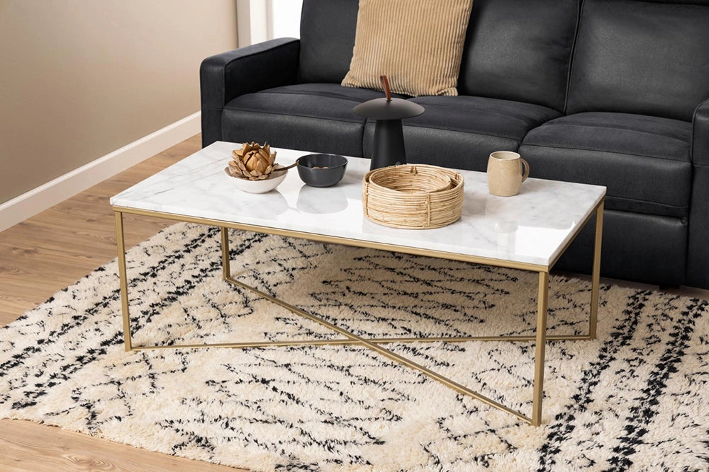 Lysa Rectangular Coffee Table in Marble Brass Finish with Upholstered Black Sofa and White Carpet in Living Room Setting