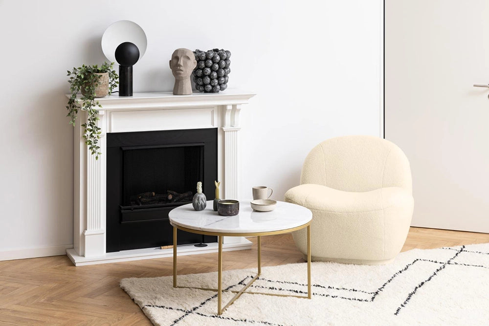 Lysa Round Coffee Table in Marble Brass Finishes with Chair and Indoor Plant in Living Room Setting