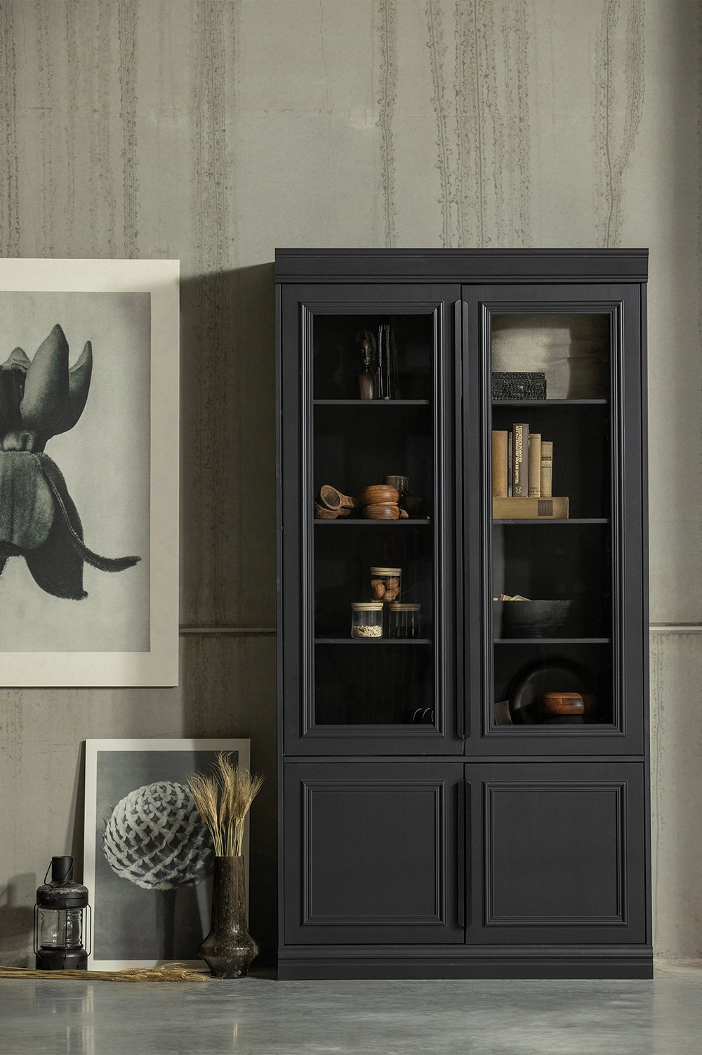 Maca Display Cabinet in Matte Black Finish with Condiments and Wall Frame in Living Room Setting